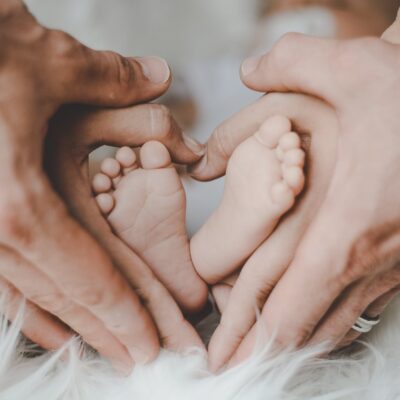 person holding baby s feet